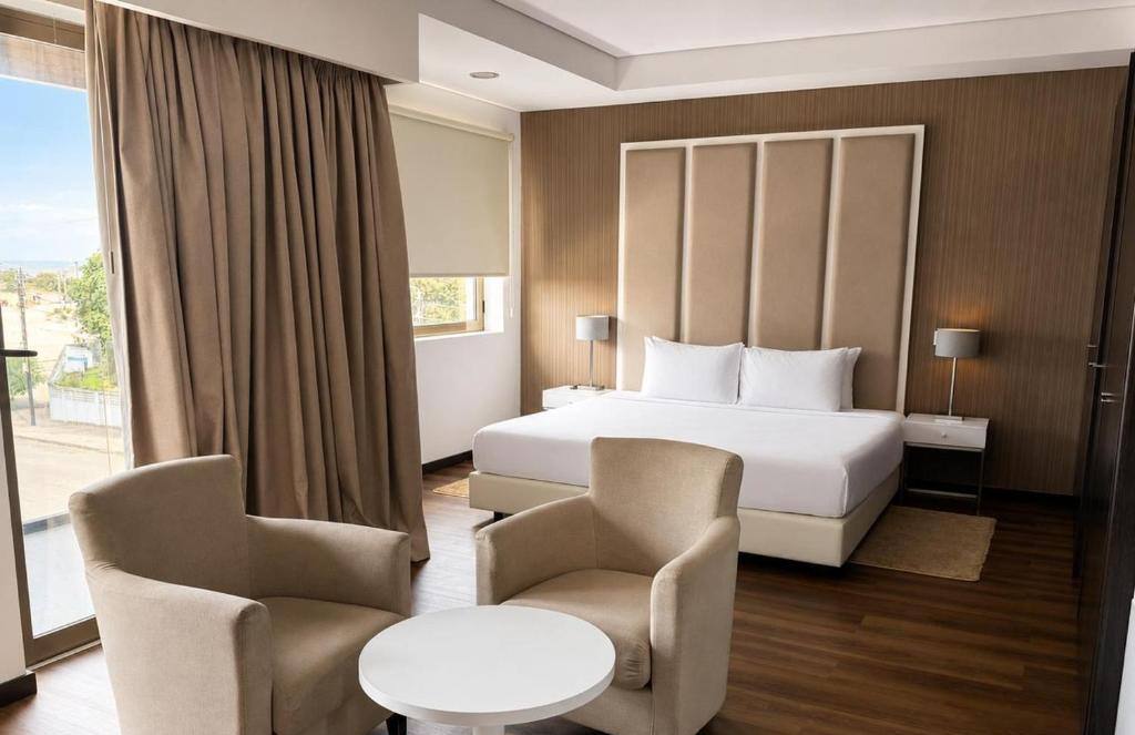 Room with upholstered headboard and seating